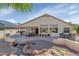 A private backyard features a dining area, a serene pond, and desert landscaping at 17806 N Becke Ln, Surprise, AZ 85374