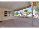Spacious covered patio with ceiling fan overlooking the tranquil backyard and landscaping at 17806 N Becke Ln, Surprise, AZ 85374