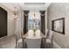 Elegant dining room featuring a chandelier, large window with curtains, and seating for six at 17806 N Becke Ln, Surprise, AZ 85374