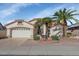 Charming single-story home features a two-car garage, stucco exterior, and desert landscaping with palm trees at 17806 N Becke Ln, Surprise, AZ 85374
