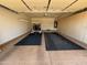Spacious garage with epoxy floors, storage cabinets, a golf cart, and access to interior door at 17806 N Becke Ln, Surprise, AZ 85374