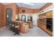 Open kitchen featuring a breakfast bar, ample counter space, tile flooring, and stainless steel appliances at 17806 N Becke Ln, Surprise, AZ 85374