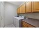 Well-organized laundry room with overhead cabinets, countertop, and modern washer and dryer at 17806 N Becke Ln, Surprise, AZ 85374