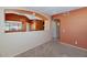 Open-concept living area with neutral carpeting and wall accents, leading to adjacent rooms through elegant archways at 17806 N Becke Ln, Surprise, AZ 85374