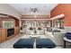 Inviting living room featuring vaulted ceilings, a ceiling fan, neutral decor, and ample natural light at 17806 N Becke Ln, Surprise, AZ 85374