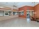 Bright open living room with large windows, tile flooring, and a dining area at 17806 N Becke Ln, Surprise, AZ 85374
