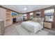 Tranquil primary bedroom with a fireplace, plush bed, ceiling fan, and access to outdoor balcony through double doors at 17806 N Becke Ln, Surprise, AZ 85374