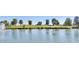 Scenic view of lush green golf course with tranquil pond and fountain feature at 17806 N Becke Ln, Surprise, AZ 85374