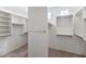 Walk-in closet with custom shelving and ample hanging space, providing stylish storage solutions for an organized wardrobe at 17806 N Becke Ln, Surprise, AZ 85374
