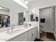 Bathroom with double sinks, a walk-in closet, and a glass shower at 17850 N 68Th St # 1037, Phoenix, AZ 85054
