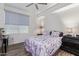 Comfortable bedroom with a ceiling fan, a window with a shade, and two nightstands at 17850 N 68Th St # 1037, Phoenix, AZ 85054
