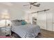 Bright bedroom featuring striped bedding, wood floors, and a sliding barn door to the bathroom at 17850 N 68Th St # 1037, Phoenix, AZ 85054