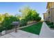A well-maintained community grill area with lush landscaping and a sidewalk at 17850 N 68Th St # 1037, Phoenix, AZ 85054