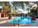A community pool surrounded by trees, lounge chairs, and shade at 17850 N 68Th St # 1037, Phoenix, AZ 85054