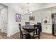 Cozy dining area with dark wood table, four chairs, and stylish lighting fixture at 17850 N 68Th St # 1037, Phoenix, AZ 85054