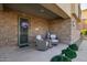Charming front porch with brick accents, seating, and a welcoming decorated front door at 17850 N 68Th St # 1037, Phoenix, AZ 85054