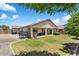 Large backyard features a covered patio and lush lawn perfect for entertaining and outdoor enjoyment at 18237 W Port Au Prince Ln, Surprise, AZ 85388