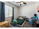 Bedroom with playful decor, plush gray bed, and large bright window at 18237 W Port Au Prince Ln, Surprise, AZ 85388