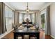 Elegant dining room showcasing a dark wood table, modern chandelier, and natural light at 18237 W Port Au Prince Ln, Surprise, AZ 85388