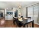 Dining room with hardwood floors next to modern kitchen with blue accents at 18237 W Port Au Prince Ln, Surprise, AZ 85388
