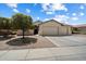 Charming home featuring a three-car garage, lush landscaping, and neutral color palette at 18237 W Port Au Prince Ln, Surprise, AZ 85388