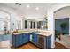 Modern kitchen with stainless steel appliances, an undermount sink, and a view to the living room at 18237 W Port Au Prince Ln, Surprise, AZ 85388