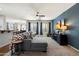 Comfortable living room with an entertainment center, neutral carpet, and ample natural light at 18237 W Port Au Prince Ln, Surprise, AZ 85388