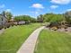Picturesque walking path winding through a lush community park provides a tranquil retreat at 18237 W Port Au Prince Ln, Surprise, AZ 85388