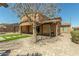 Spacious backyard featuring a covered patio and lush greenery at 18483 W Paradise Ln, Surprise, AZ 85388