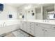 This bathroom has a double vanity, neutral tiling, and a separate tub at 18483 W Paradise Ln, Surprise, AZ 85388