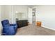 Inviting bedroom with a comfortable blue chair and a decorative dresser at 18483 W Paradise Ln, Surprise, AZ 85388