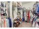 This walk-in closet has two tiers of rods for maximum storage capacity at 18483 W Paradise Ln, Surprise, AZ 85388