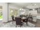 Open concept dining area features modern lighting, backyard views, and flows into the kitchen at 18483 W Paradise Ln, Surprise, AZ 85388