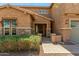 Inviting home exterior with stone accents, covered entry, and manicured landscaping at 18483 W Paradise Ln, Surprise, AZ 85388