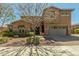 Charming two-story home boasts a well-manicured front yard and inviting curb appeal at 18483 W Paradise Ln, Surprise, AZ 85388