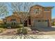 Charming two-story home boasts a well-manicured front yard and inviting curb appeal at 18483 W Paradise Ln, Surprise, AZ 85388
