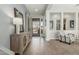 Bright foyer featuring wood-look tile flooring and stylish decor at 18483 W Paradise Ln, Surprise, AZ 85388