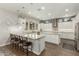 Bright kitchen with large island, stainless steel appliances, and tile backsplash at 18483 W Paradise Ln, Surprise, AZ 85388