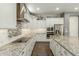 Modern kitchen featuring stainless steel appliances, white cabinets, and granite countertops at 18483 W Paradise Ln, Surprise, AZ 85388