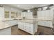 Spacious kitchen with white cabinets, granite countertops, and a center island at 18483 W Paradise Ln, Surprise, AZ 85388