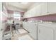 Well-organized laundry room with ample storage and modern appliances at 18483 W Paradise Ln, Surprise, AZ 85388