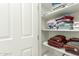 Well-organized linen closet with neatly stacked towels on bright white shelving at 18483 W Paradise Ln, Surprise, AZ 85388