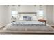 The room is decorated with patterned pillows and throw at the foot of the bed at 18483 W Paradise Ln, Surprise, AZ 85388
