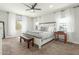 This bedroom offers a ceiling fan, neutral carpeting, and views to the outside at 18483 W Paradise Ln, Surprise, AZ 85388