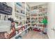 Spacious walk-in pantry featuring lots of shelving and wood-look floors at 18483 W Paradise Ln, Surprise, AZ 85388