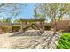 An outdoor pergola with seating and a table provides shade over a brick-paved area at 18483 W Paradise Ln, Surprise, AZ 85388