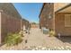 A side yard area with gravel and concrete pavers between the house and perimeter wall at 18483 W Paradise Ln, Surprise, AZ 85388