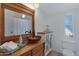 Bathroom with a decorative mirror, vanity with a vessel sink, and a window for natural light at 201 S Greenfield Rd # 255, Mesa, AZ 85206