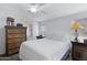 Comfortable bedroom with vintage dresser, ceiling fan and an en suite bathroom at 201 S Greenfield Rd # 255, Mesa, AZ 85206