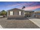 Charming single-story home with desert landscaping, carport, and a calming blue-pink sky at 201 S Greenfield Rd # 255, Mesa, AZ 85206